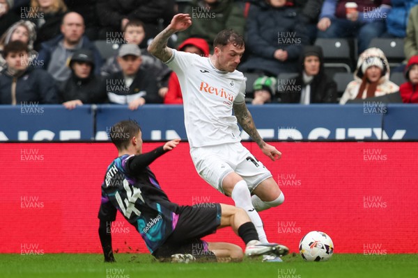 210226 - Swansea City v Bristol City - Sky Bet Championship - George Earthy of Bristol City tackles Josh Tymon of Swansea City 