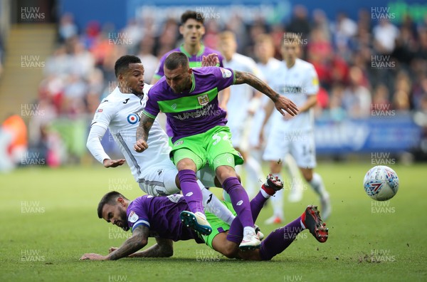 250818 - Swansea City v Bristol City, Sky Bet Championship - Martin Olsson of Swansea City is challenged by Jack Hunt of Bristol City and Marlon Pack of Bristol City