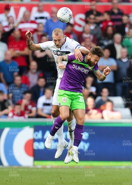 250818 - Swansea City v Bristol City, Sky Bet Championship - Mike van der Hoorn of Swansea City and Matty Taylor of Bristol City compete for the ball