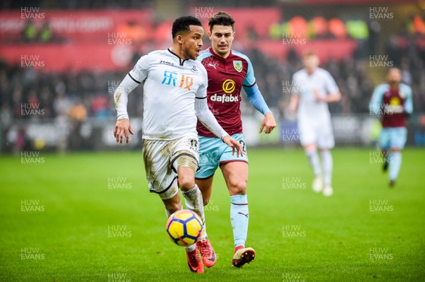 100218 - Swansea City v Burnley - Premier League - Martin Olsson of Swansea City is chased down by Matthew Lowton of Burnley 