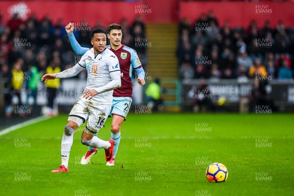 100218 - Swansea City v Burnley - Premier League - Martin Olsson of Swansea City and Matthew Lowton of Burnley chase the ball 