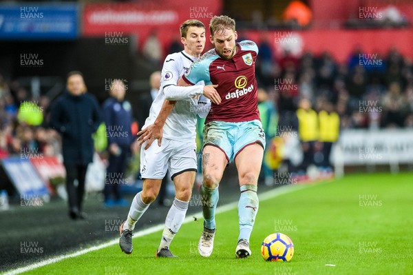 100218 - Swansea City v Burnley - Premier League - Tom Carroll of Swansea City tries to takes the ball from Charlie Taylor of Burnley 