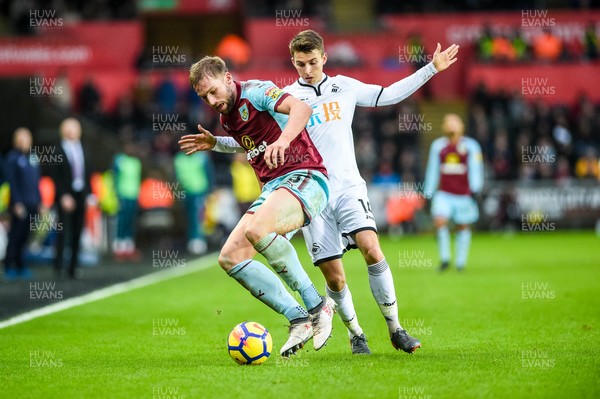 100218 - Swansea City v Burnley - Premier League - Tom Carroll of Swansea City tries to takes the ball from Charlie Taylor of Burnley 