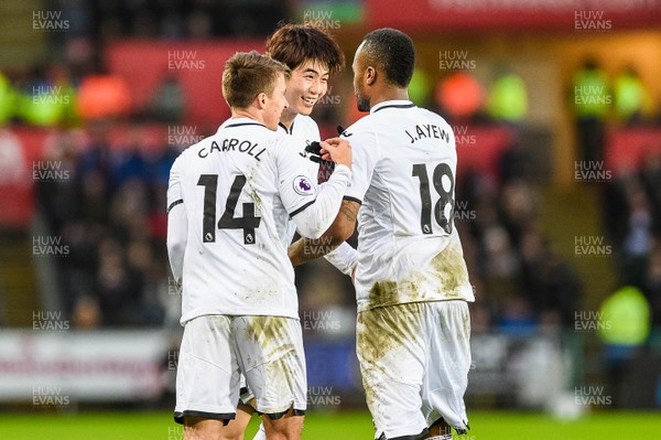 100218 - Swansea City v Burnley - Premier League - Ki Sung Yueng of Swansea City Celebrates his goal with Tom Carroll and Jordan Ayew 