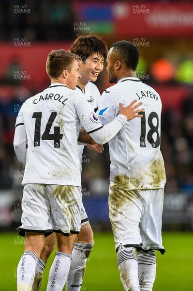 100218 - Swansea City v Burnley - Premier League - Ki Sung Yueng of Swansea City Celebrates his goal with Tom Carroll and Jordan Ayew 