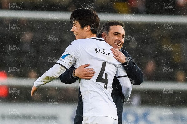 100218 - Swansea City v Burnley - Premier League - Ki Sung Yueng of Swansea City  embraces manager Carlos Carvalhal at final whistle 