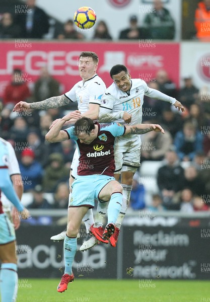 100218 - Swansea City v Burnley, Premier League - Ashley Barnes of Burnley competes with Alfie Mawson of Swansea City and Martin Olsson of Swansea City as they look to win the ball