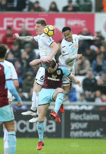100218 - Swansea City v Burnley, Premier League - Ashley Barnes of Burnley competes with Alfie Mawson of Swansea City and Martin Olsson of Swansea City as they look to win the ball