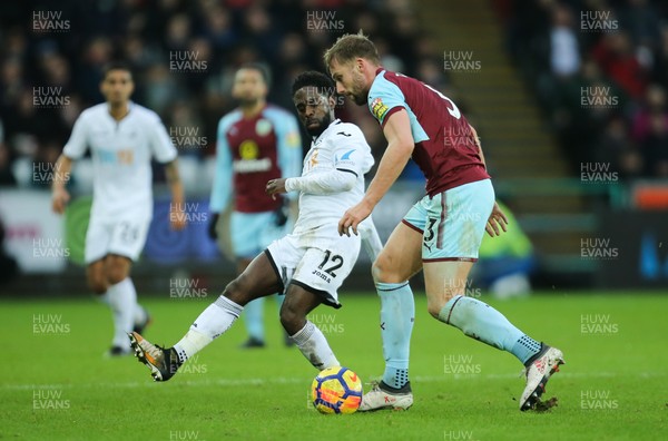 100218 - Swansea City v Burnley, Premier League - Nathan Dyer of Swansea City and Charlie Taylor of Burnley compete for the ball