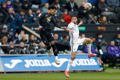 150325 - Swansea City v Burnley - Sky Bet Championship - Marcus Edwards of Burnley challenges for the aerial ball with Ronald of Swansea City