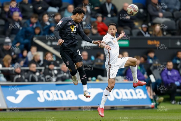 150325 - Swansea City v Burnley - Sky Bet Championship - Marcus Edwards of Burnley challenges for the aerial ball with Ronald of Swansea City