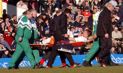 150203 - Swansea City v Cambridge United - Third Division - Swansea's Terry Evans is stretchered off