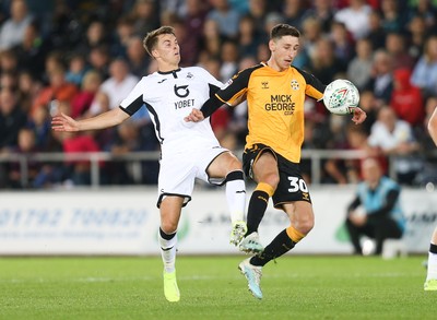 280819 - Swansea City v Cambridge United, Carabao Cup, Round 2 - Tom Carroll of Swansea City and \c30\ compete for the ball