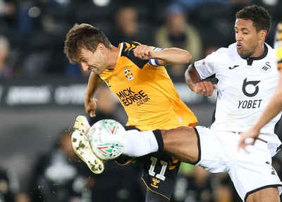 280819 - Swansea City v Cambridge United, Carabao Cup, Round 2 - Wayne Routledge of Swansea City and Harrison Dunk of Cambridge United compete for the ball