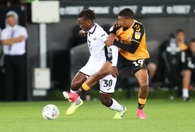 280819 - Swansea City v Cambridge United, Carabao Cup, Round 2 - Tivonge Rushesha of Swansea City  is brought down by Reggie Lambe of Cambridge United