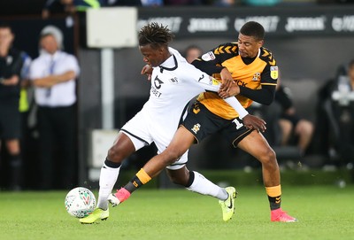 280819 - Swansea City v Cambridge United, Carabao Cup, Round 2 - Tivonge Rushesha of Swansea City  is brought down by Reggie Lambe of Cambridge United