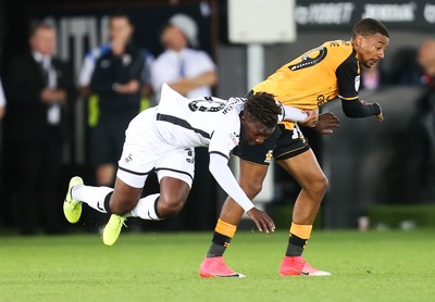 280819 - Swansea City v Cambridge United, Carabao Cup, Round 2 - Tivonge Rushesha of Swansea City  is brought down by Reggie Lambe of Cambridge United