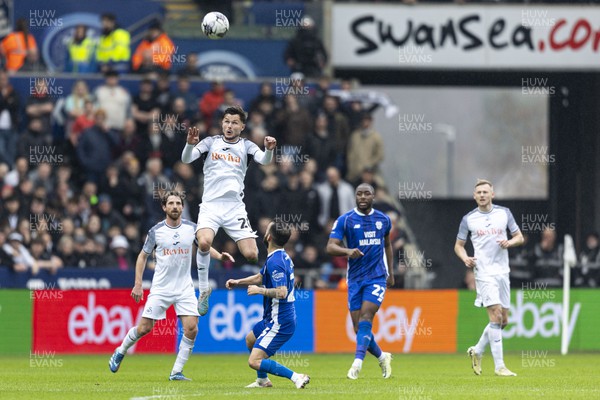 160324 - Swansea City v Cardiff City - Sky Bet Championship - Liam Cullen of Swansea City wins a header over Manolis Siopis of Cardiff City