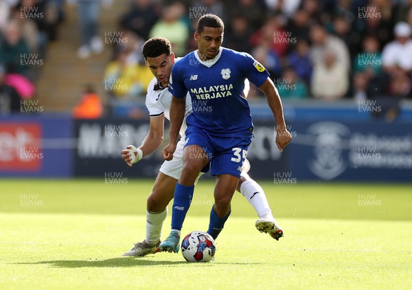 231022 - Swansea City v Cardiff City, South Wales Derby - SkyBet Championship - Andy Rinomhota of Cardiff City is challenged by Ben Cabango of Swansea City