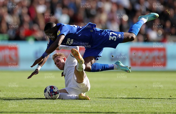231022 - Swansea City v Cardiff City, South Wales Derby - SkyBet Championship - Niels Nkounkou of Cardiff City is tackled by Ollie Cooper of Swansea City