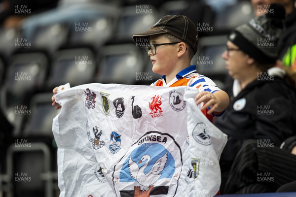 231022 - Swansea City v Cardiff City - Sky Bet Championship - A young Swansea flag with a flag during the warm up
