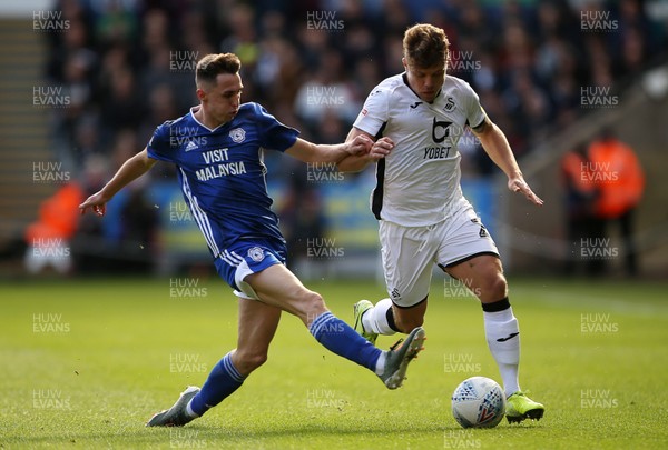 271019 - Swansea City v Cardiff City - SkyBet Championship - Jake Bidwell of Swansea City is tackled by Gavin Whyte of Cardiff City