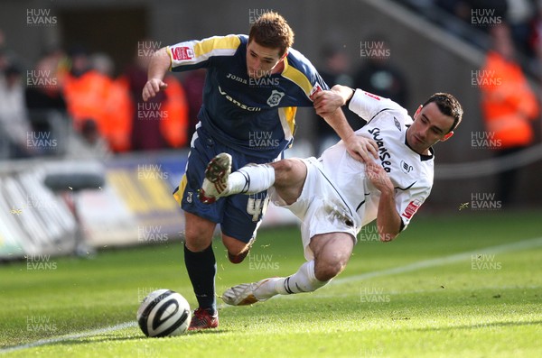 30.11.08 ... Swansea City v Cardiff City, Coca Cola Championship.  -  Cardiff's Ross McCormack is tackled by Swansea's Leon Britton 