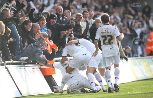 30.11.08 ... Swansea City v Cardiff City, Coca Cola Championship.  -  Swansea's Darren Pratley  is mobbed by team-mates and fans after scoring the opening goal 