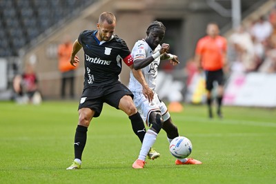 010826 - Swansea City v CD Leganes - Preseason Friendly - Moussa Yeo of Swansea City is challenged by Enric Franquesa of Leganes
