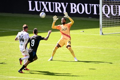 010826 - Swansea City v CD Leganes - Preseason Friendly - Alejandro Millan Iranzo of Leganes attempts a lob over Lawrence Vigouroux of Swansea City