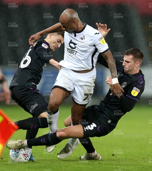 020120 - Swansea City v Charlton Athletic - SkyBet Championship - Andre Ayew of Swansea City is tackled by James Vennings and Ben Purrington of Charlton Athletic