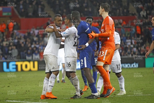 280418 - Swansea City v Chelsea, Premier League - Jordan Ayew of Swansea City (left) and Antonio Rudiger of Chelsea (centre)are restrained by team-mates