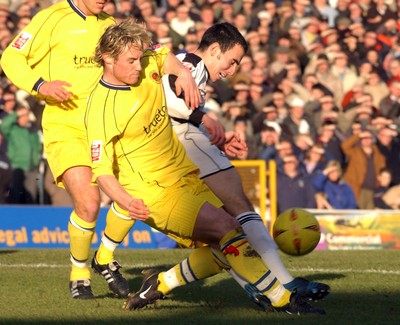 290105 - Swansea City v Chester City - League Two - Swansea's Leon Britton is taken down by a Ben Davies tackle 