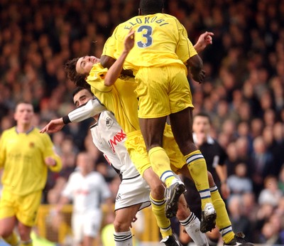 290105 - Swansea City v Chester City - League Two - Chester's Michael Brown (CTR) collides with teamate George Elokobi and Swansea's Leon Britton causing him to leave the field on a strecher