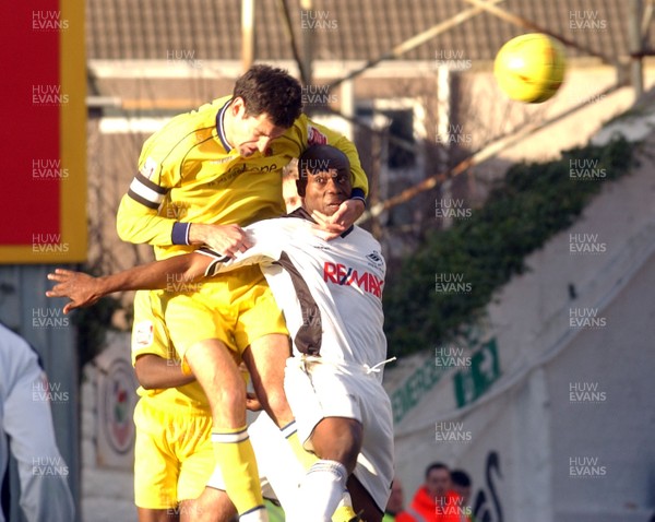 290105 - Swansea City v Chester City - League Two - Chester's Phil Bolland and Ezomo Ieiekpen challenge for a high ball