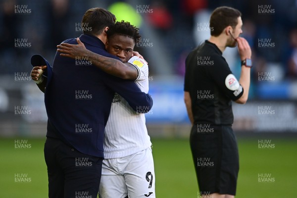 050322 - Swansea City v Coventry City - Sky Bet Championship - Russell Martin Head Coach of Swansea City hugs Michael Obafemi of Swansea City after taking him off 