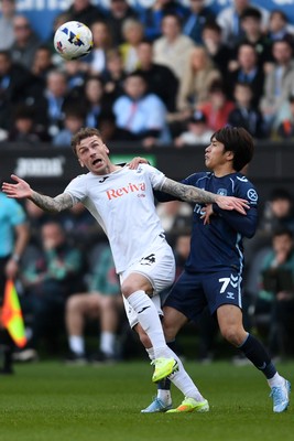 210326 - Swansea City v Coventry City - Sky Bet Championship - Josh Tymon of Swansea City is challenged by Tatsuhiro Sakamoto of Coventry