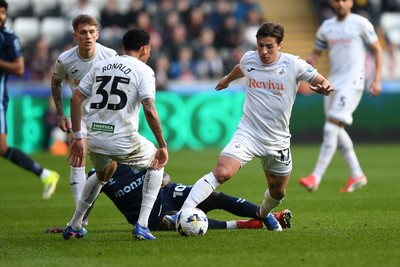 210326 - Swansea City v Coventry City - Sky Bet Championship - Goncalo Franco of Swansea City is challenged by Ephron Mason-Clark of Coventry