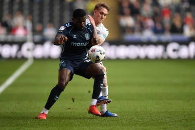210326 - Swansea City v Coventry City - Sky Bet Championship - Ethan Galbraith of Swansea City is challenged by Ephron Mason-Clark of Coventry