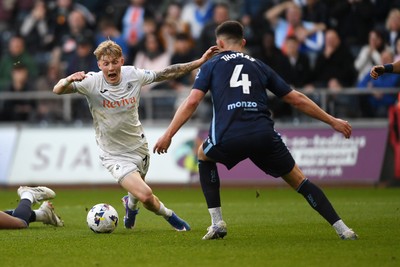 210326 - Swansea City v Coventry City - Sky Bet Championship - Melker Widell of Swansea City is challenged by Bobby Thomas of Coventry