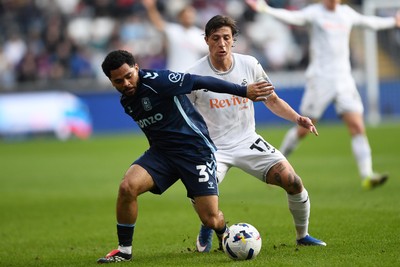 210326 - Swansea City v Coventry City - Sky Bet Championship - Goncalo Franco of Swansea City is challenged by Jay Dasilva of Coventry