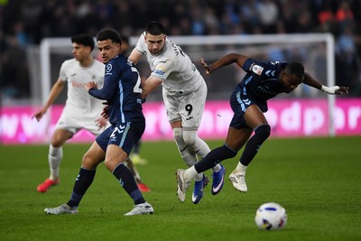 210326 - Swansea City v Coventry City - Sky Bet Championship - Zan Vipotnik of Swansea City is challenged by Joel Latibeaudiere of Coventry