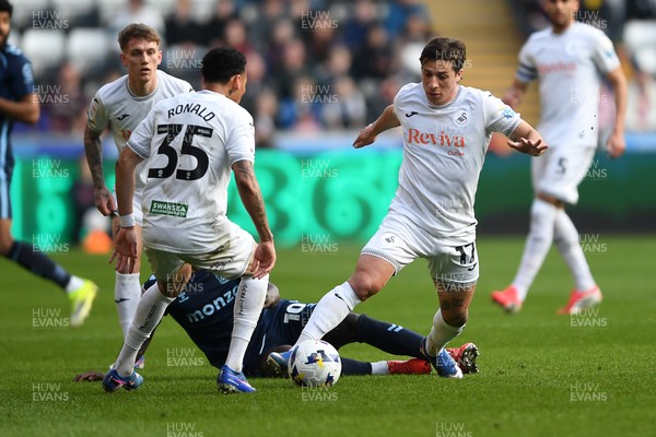 210326 - Swansea City v Coventry City - Sky Bet Championship - Goncalo Franco of Swansea City is challenged by Ephron Mason-Clark of Coventry