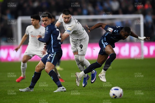 210326 - Swansea City v Coventry City - Sky Bet Championship - Zan Vipotnik of Swansea City is challenged by Joel Latibeaudiere of Coventry