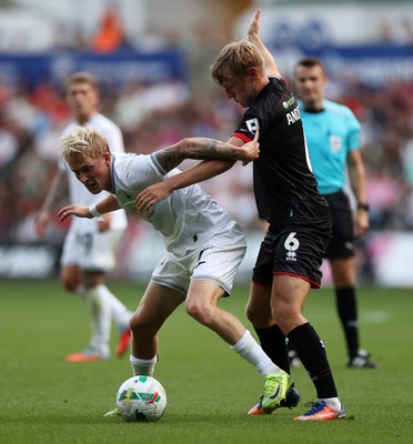 120825 - Swansea City v Crawley Town, Carabao Cup - Melker Widell of Swansea City is challenged by Max Anderson of Crawley Town 