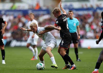 120825 - Swansea City v Crawley Town, Carabao Cup - Melker Widell of Swansea City is challenged by Max Anderson of Crawley Town 