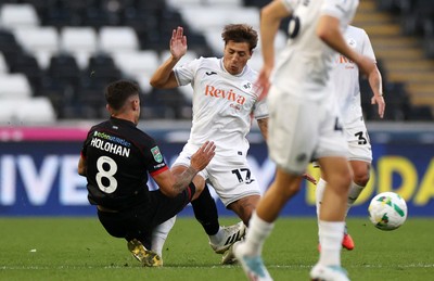 120825 - Swansea City v Crawley Town, Carabao Cup - Gavan Holohan of Crawley Town is given a red card for this tackle on Goncalo Franco of Swansea City 
