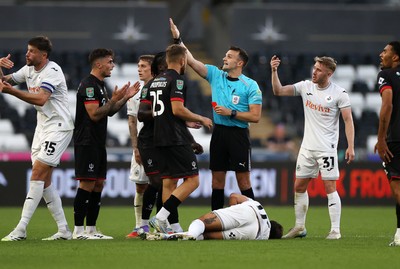120825 - Swansea City v Crawley Town, Carabao Cup - Gavan Holohan of Crawley Town is given a red card by referee Ben Speedie