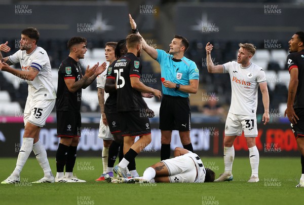 120825 - Swansea City v Crawley Town, Carabao Cup - Gavan Holohan of Crawley Town is given a red card by referee Ben Speedie