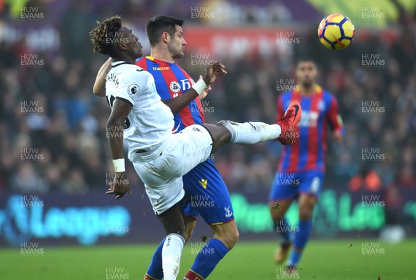 231217 - Swansea City v Crystal Palace - Premier League - Tammy Abraham of Swansea City is tackled by Scott Dann of Crystal Palace